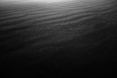 A cool greyscale background of black and grey layered stone fragmentsの写真素材