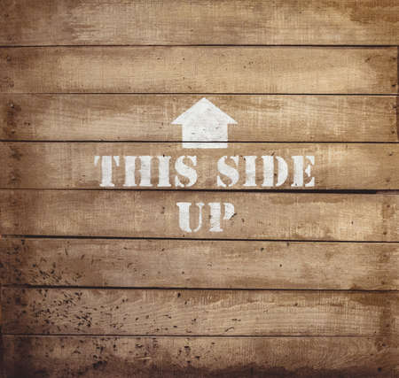 A closeup shot of a wooden surface with an arrow painted on it - great for background
