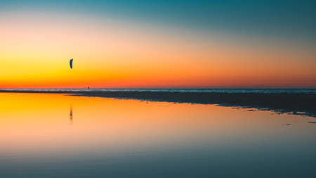 A beautiful view of the reflection of the sun in the lake captured in Vrouwenpolder, Netherlandsの写真素材