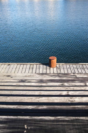 A vertical shot of the wooden pier by the water captured in Copenhagen, Denmarkの写真素材