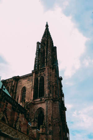 A vertical low angle shot of Notre Dame Cathedral captured in Strasbourg, Franceの写真素材