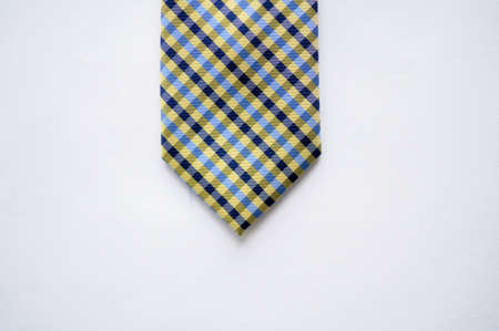 An overhead shot of a blue striped tie on a white surfaceの写真素材