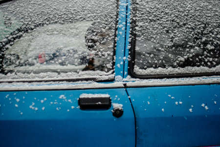 An old blue car covered with snow - great for wallpaper or backgroundの写真素材