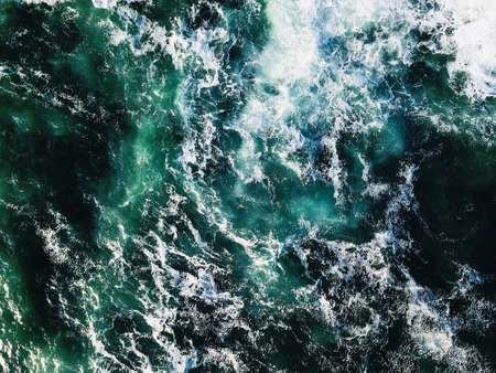 A high angle shot of the foamy turquoise water of the oceanの写真素材