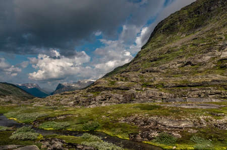 A beautiful shot of high rock formations covered with grass in Norwayの写真素材