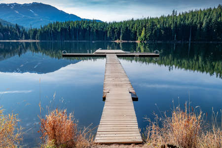 A beautiful green scenery reflecting in the Lost Lake in Whistler, BC Canadaの写真素材