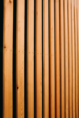 A vertical shot of brown wood panels - great for a backgroundの写真素材
