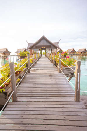 A vertical shot of a wooden path to the overwater  bungalows in Kapalai Resort in Malaysia - perfect...