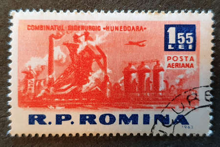 SOVATA, ROMANIA - Jul 02, 2020: an old postage stamp from Romania 1963 with the image of a factory built during the communist period,seriesのeditorial素材