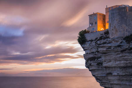 A building on a cliff over the ocean at twilightのeditorial素材