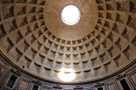 A low angle shot of the inside of a concrete dome with a hole