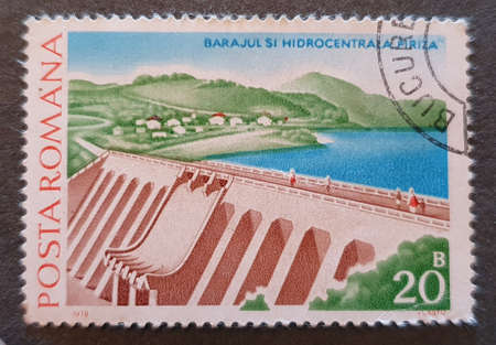 SOVATA, ROMANIA - Jul 02, 2020: an old postage stamp from Romania 1978 with the theme of dams and hydropower plants from romaniaのeditorial素材
