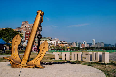 A low angle shot of an anchor near the Tamsui sign in Tamsui District, Taiwan