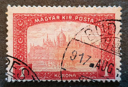 SOVATA, ROMANIA - Jul 02, 2020: old stamp from Hungary 1917 with the image of Parliament House Budapest in red colorのeditorial素材