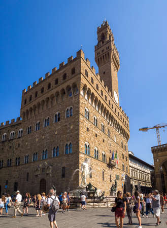 FLORENCE, ITALY - Jul 05, 2019: View on Square of Signoria and Tower of Arnolfo in Florence (Piazza della Signoria), is full of tourists who are walking on the old squareのeditorial素材