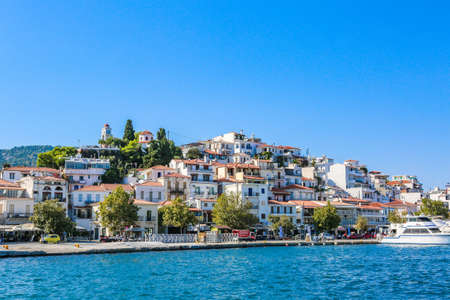 A lot of buildings on the seashore in Skiathos Town, Greece on a sunny dayのeditorial素材