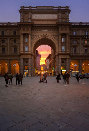 FLORENCE, ITALY - Nov 24, 2019: A colourful sunset in Florence, Italy with a piaza and gate in the...