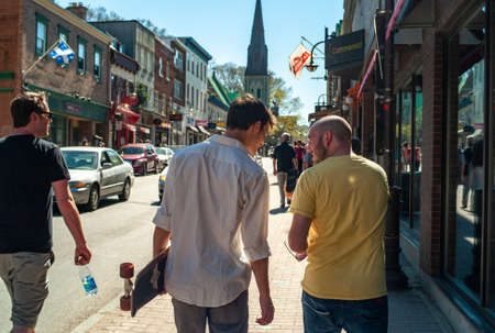 QUEBEC, CANADA - May 05, 2013: Quebec, Quebec / Canada - May 5 2013: Two Caucasian Young Male Waling in Old Quebec City. One of them is Holding a Skateboardのeditorial素材