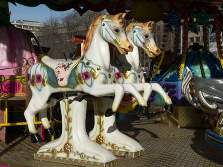 GENEVA, SWITZERLAND - Jan 04, 2020: Two white carousel horses at the fun fairの写真素材