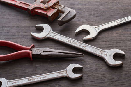 an old rusty wrenches on wooden foregroundの写真素材