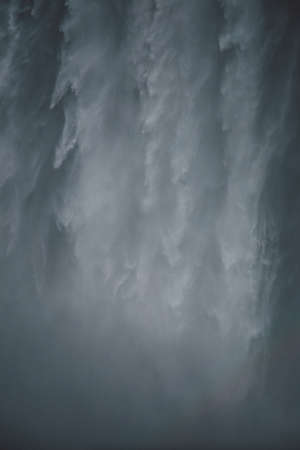 A vertical shot of a magnificent avalanche coming down the mountains