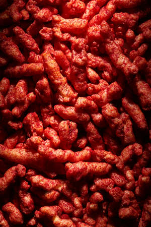 A vertical shot of spicy red crisps - great for a cool backgroundの写真素材