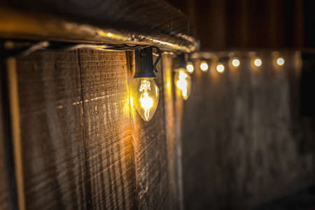 A closeup of lights on the walls during the night with a blurry background