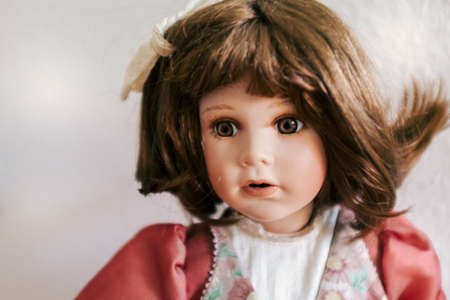 A closeup shot of a girl doll with its eyes openの写真素材