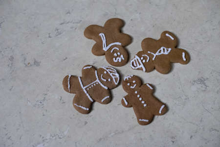 A closeup of brown Gingerbreads on an old white table under the lights