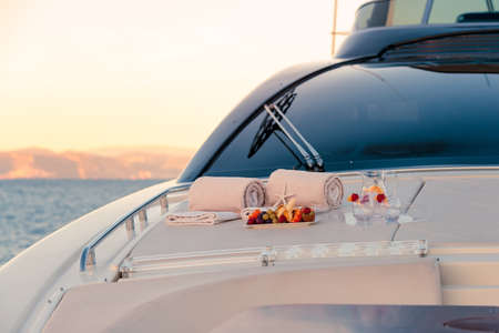 A selective focus shot of fruits on the tray near glasses on a yachtの写真素材