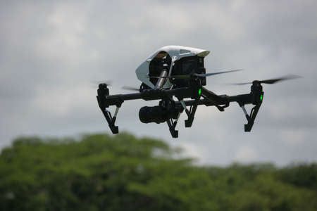 SAN SALVADOR, EL SALVADOR - Jan 13, 2020: A dji inspire 1 drone flying above some trees