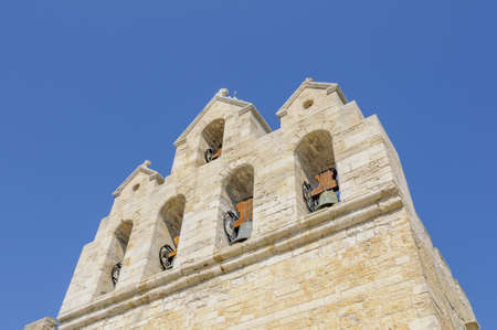 A low angle shot of the bell of of the L'eglise Notre Dame de la Mer captured in Franceの写真素材