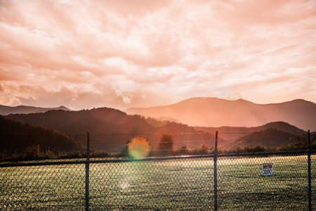 A breathtaking colorful sunset over a mountainous sceneryの写真素材