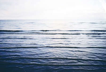 A landscape of the sea waves under sunlight in the morning with a blurry background