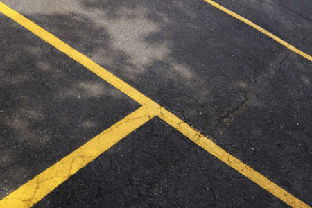 PORTLAND, UNITED STATES - Jul 26, 2019: A high angle shot of the yellow lines painted on the asphalt in a parking lotの写真素材