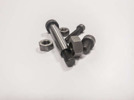 A lot of metal nuts and bolts on a white background