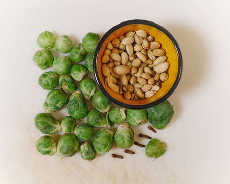 PORTLAND, UNITED STATES - Nov 23, 2019: A high angle shot of some vegetables and a bowl of beans on a white surfaceの写真素材
