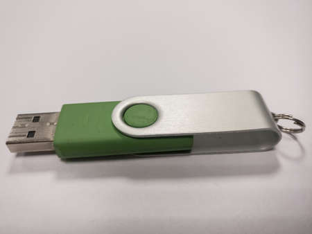 A green USB flash drive on a white background