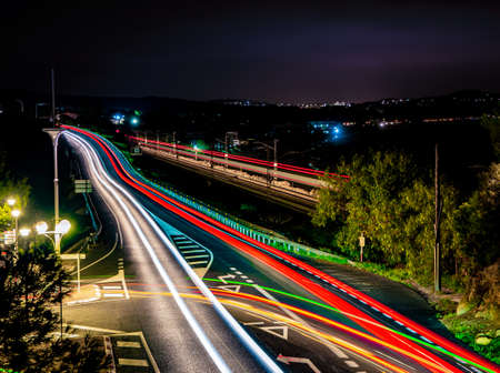 A colorful view of a bright lighted city highway road during nighttime