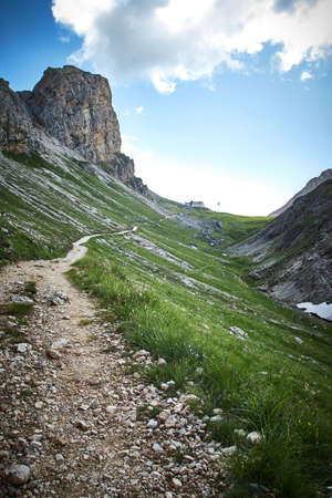 A vertical shot of a green landscape with rocky cliffs in Italyの写真素材