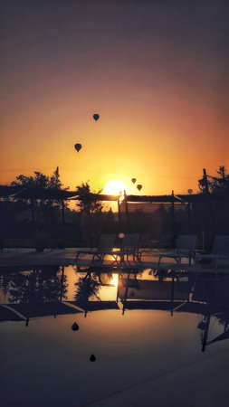 A vertical shot of parachutes flying during a breathtaking sunset