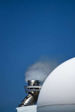 Close up vertical shot of smoke coming out of cruise ship exhaustの写真素材