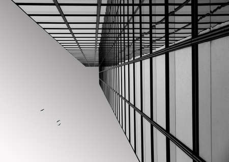 A low angle shot of a modern business building touching the clear skyの写真素材