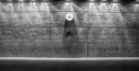 A grayscale shot of a clock on a wallの写真素材