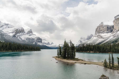 A high angle shot of a clear frozen lake surrounded by a mountainous sceneryの写真素材