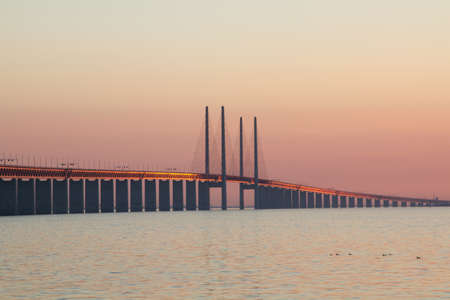 A beautiful shot of the Utsiktspunkt Ã–resundsbron bridge over the water under a beautiful sky