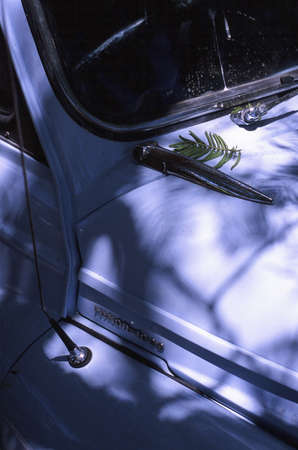 CAPE TOWN, SOUTH AFRICA - Feb 22, 2018: Old blue car under dappled light