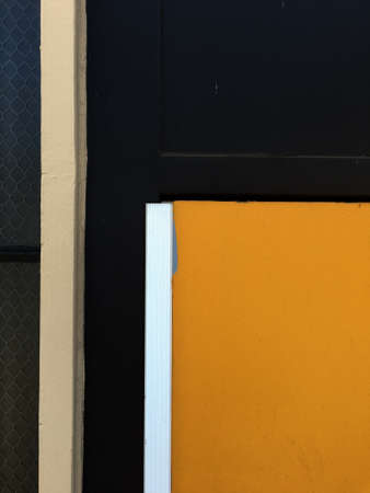 PORTLAND, UNITED STATES - May 23, 2019: A vertical shot of a metal door painted in black and yellowの写真素材