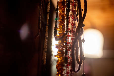 A closeup of bead jewelry under the lights with a blurry background