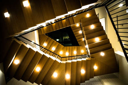 A low angle shot of a staircase going up with lights on the bottom